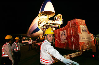 Airport workers load up a cargo plane from China Airlines, Taiwan��s largest air carrier, at Taiwan��s international airport in Taipei July 19, 2006.