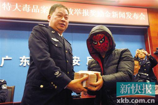 ■廣東省禁毒辦常務(wù)副主任、公安廳禁毒局局長鄧建偉向舉報(bào)者現(xiàn)場發(fā)放45萬元的獎(jiǎng)金。新快報(bào)記者 陳海生/攝